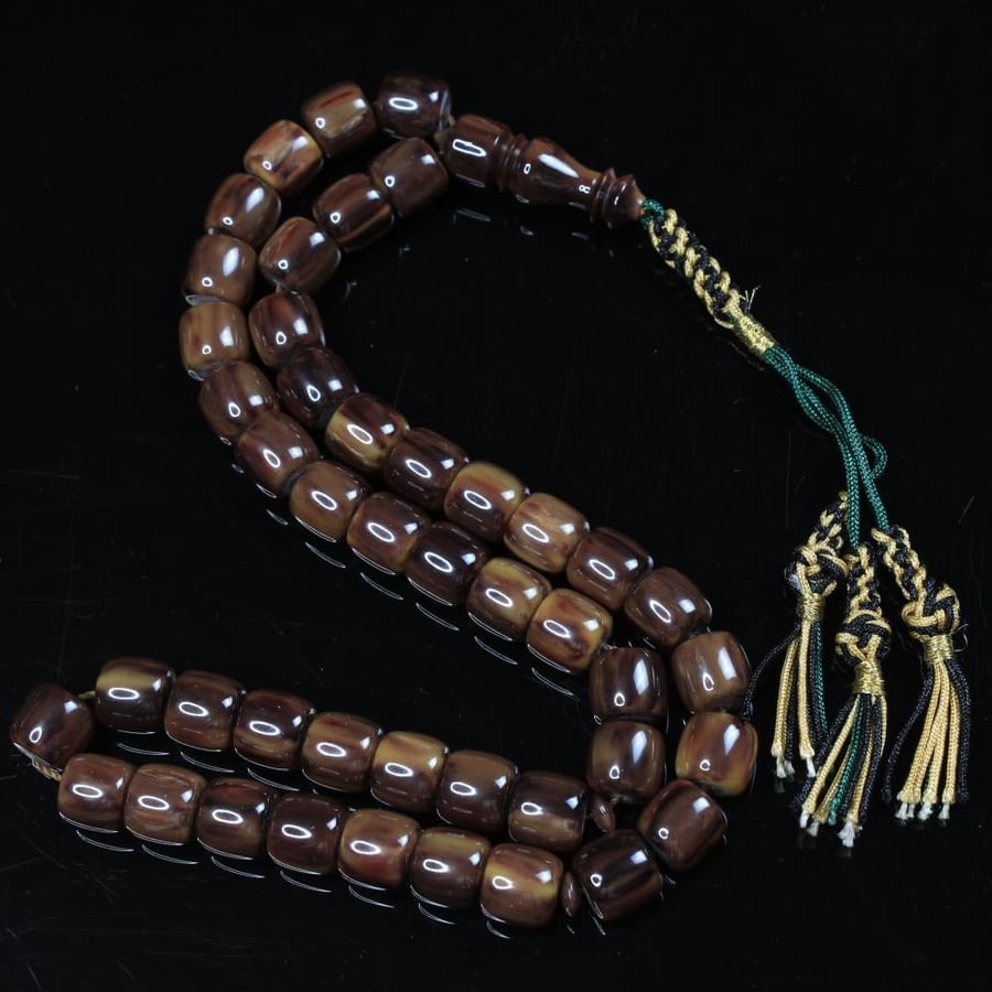 A brown musk prayer bead with a gradient cinnamon color