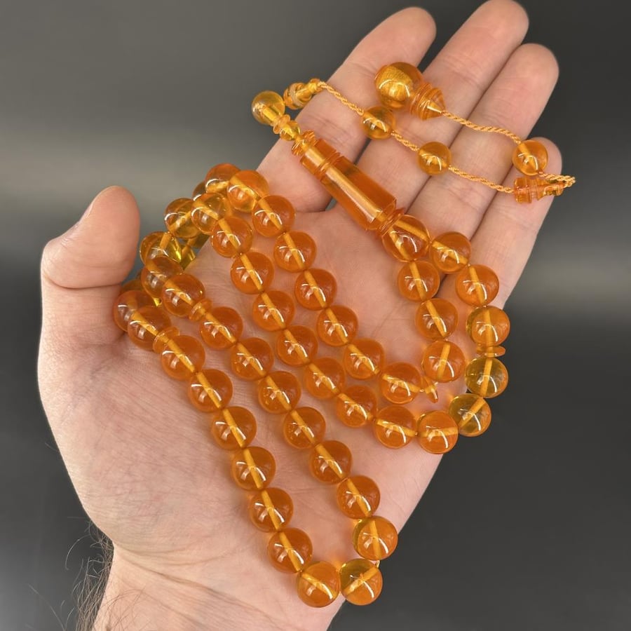 Yellow saffron-colored transparent prayer bead