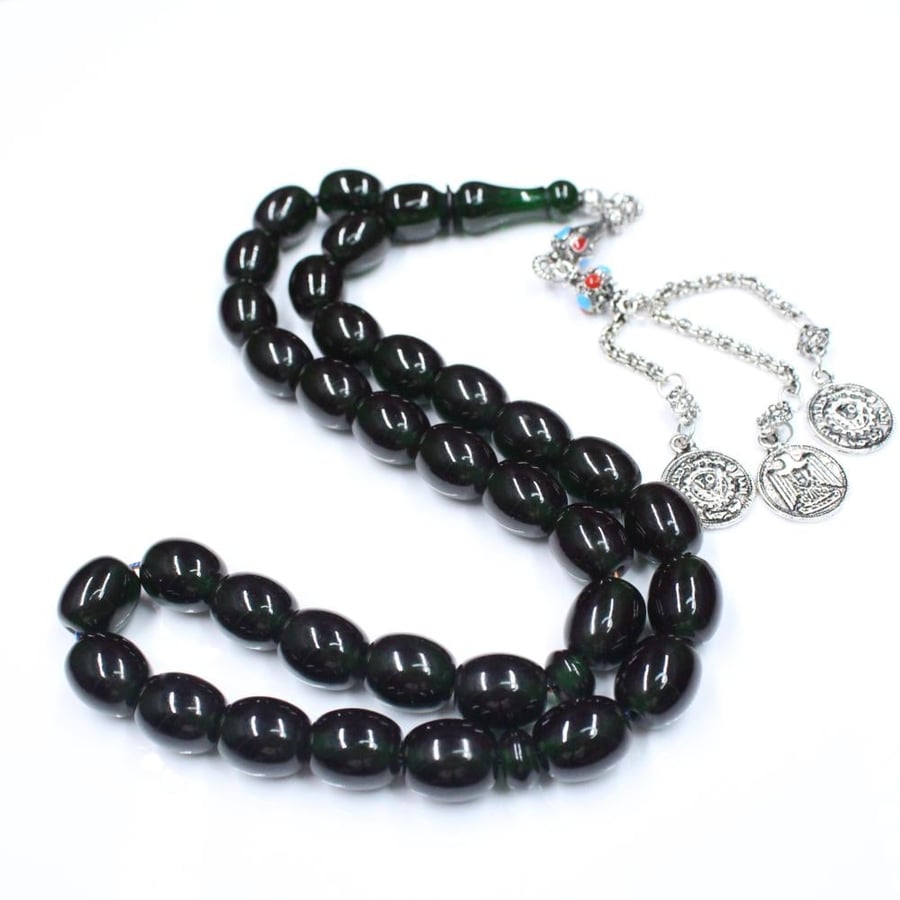 A dark green musk prayer bead with cylindrical beads and a traditional tassel