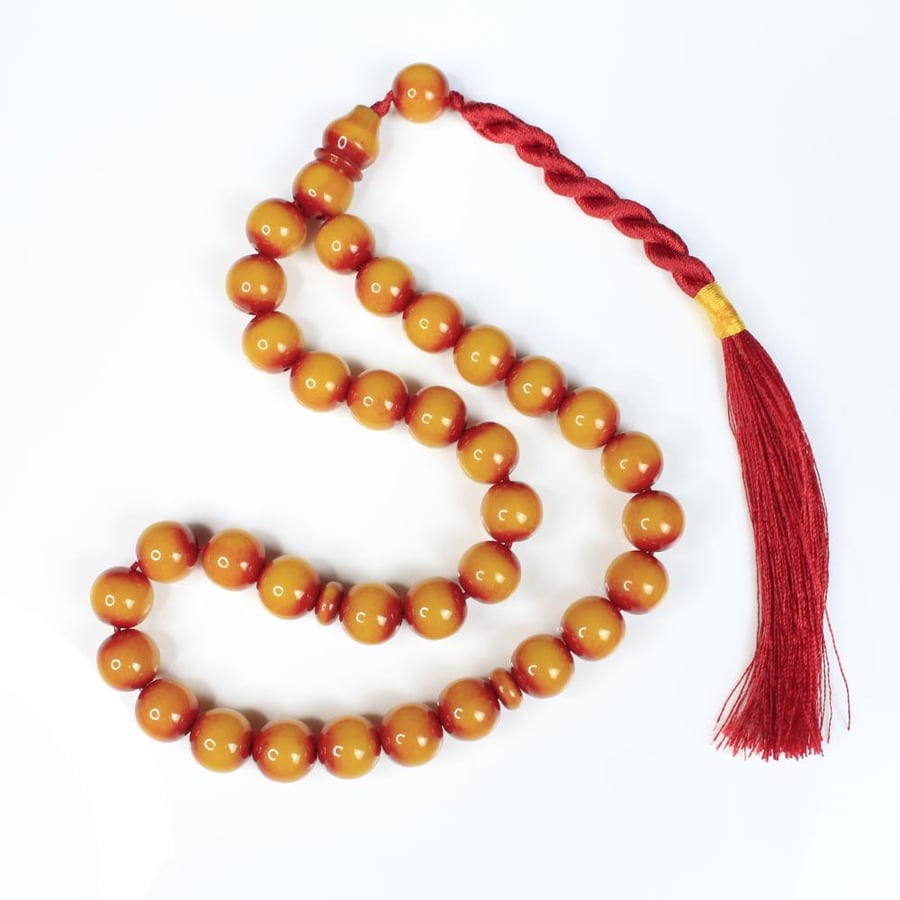 A musk prayer bead with a honey yellow color and round beads