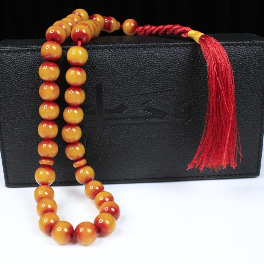A musk prayer bead with a honey yellow color and round beads
