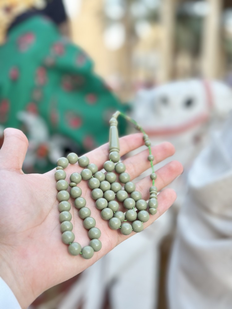 A tasbih with a royal blue and pistachio green color.