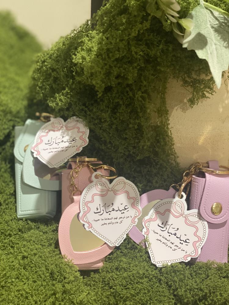 A bag pendant with a perfume bottle by the piece