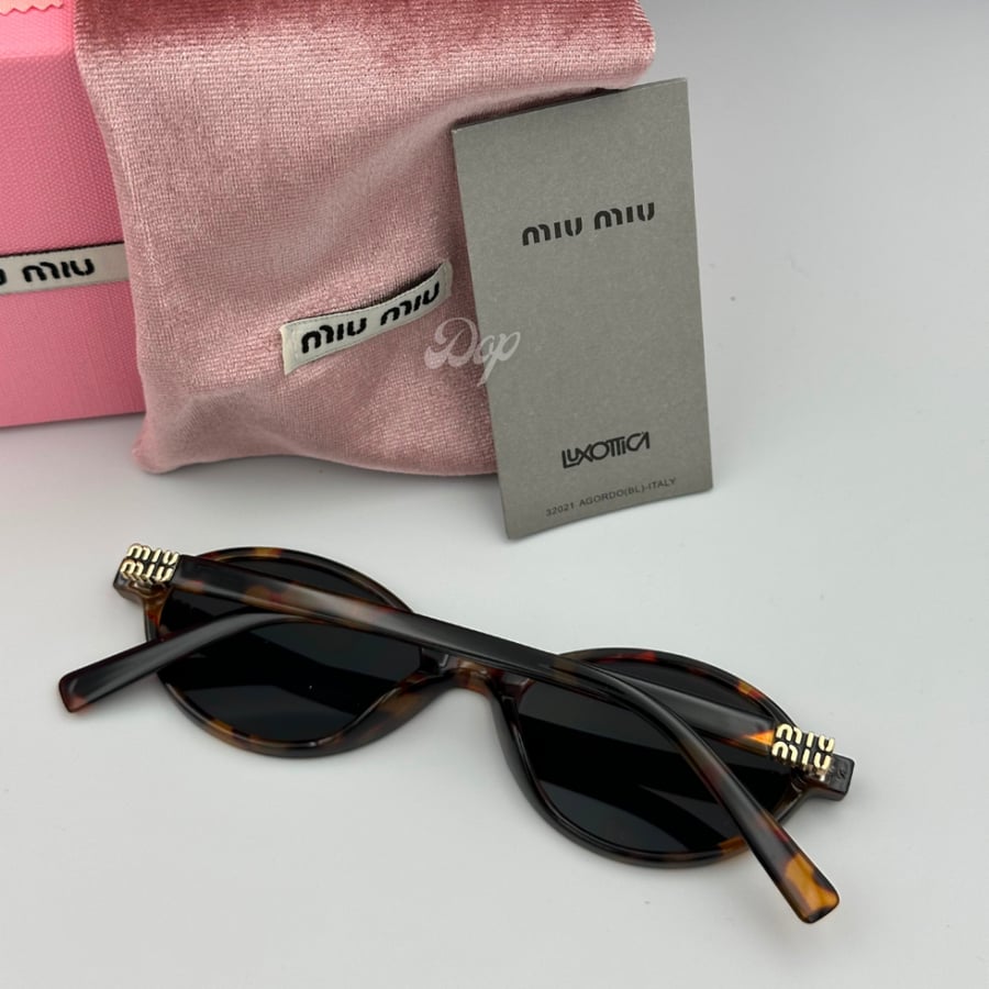 Miu Miu sunglasses with a tiger frame and round black lenses