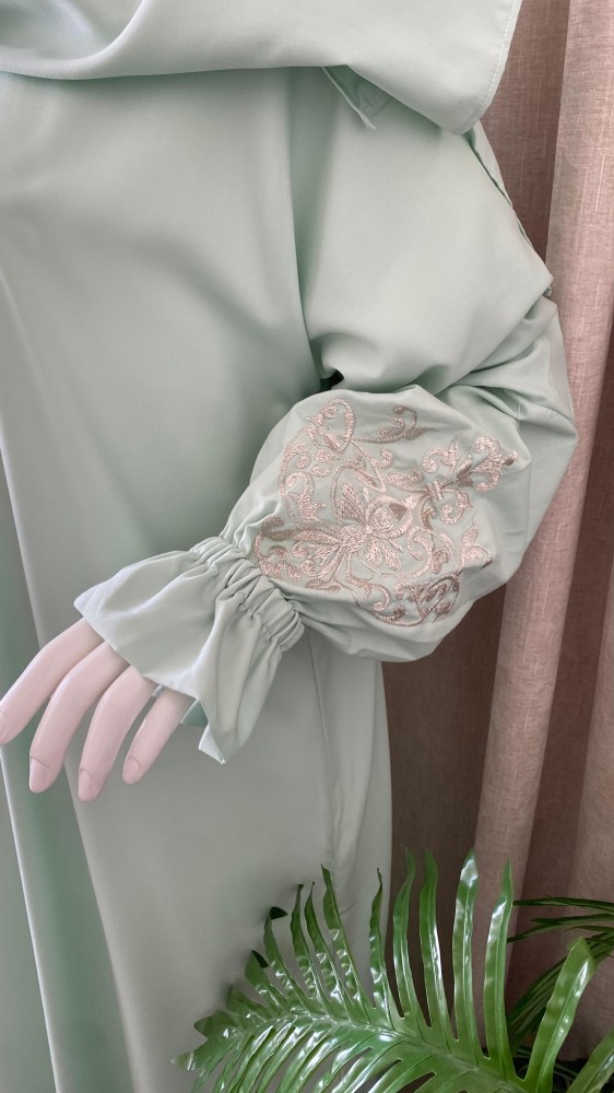 Clothing with a light green embroidered headscarf