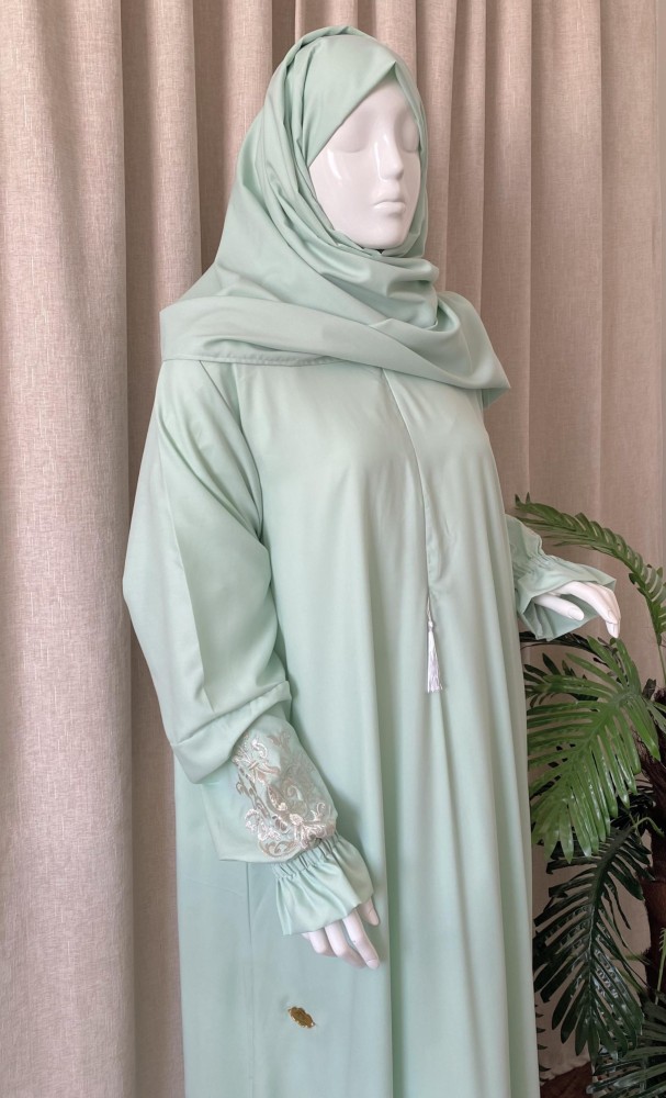 Clothing with a light green embroidered headscarf