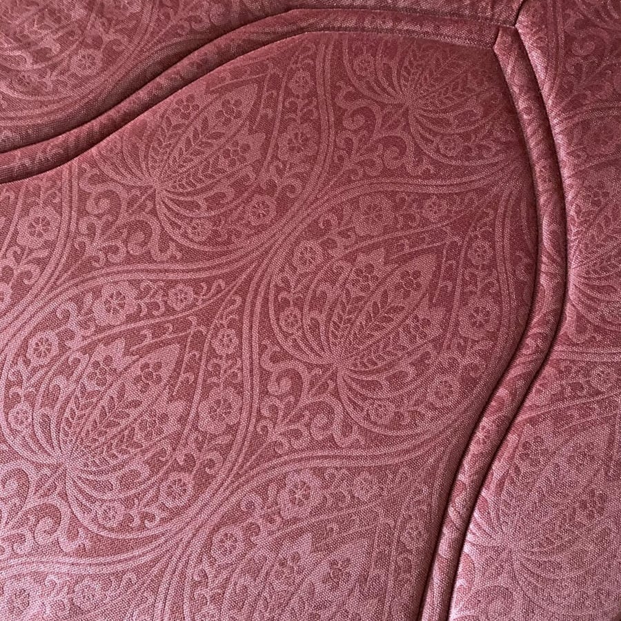 An orange-reddish prayer rug