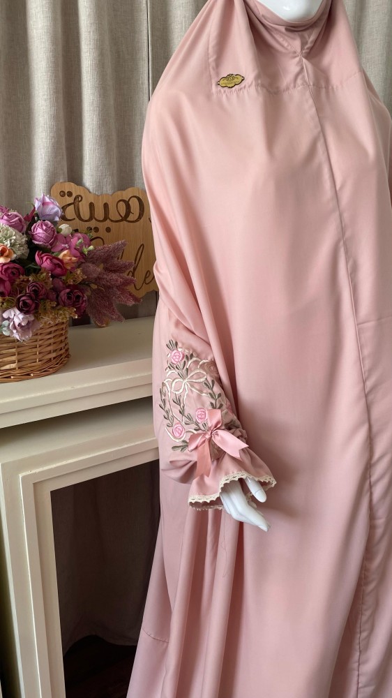 A prayer set with regular style embroidered clothing and a prayer rug