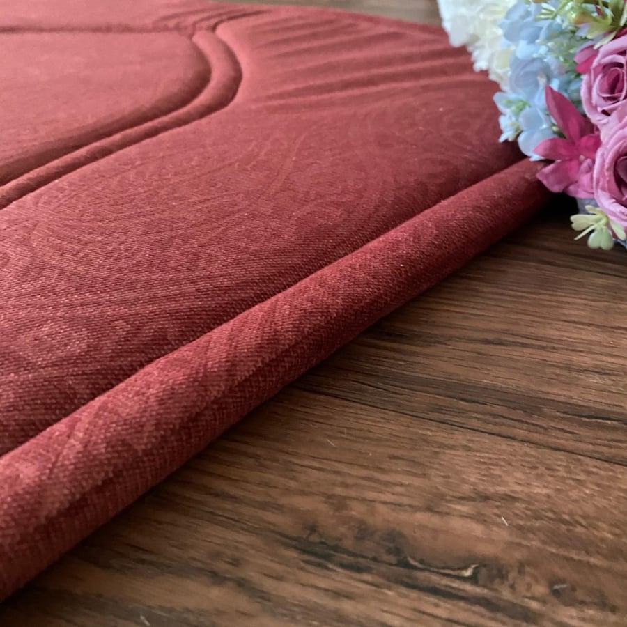 An orange-reddish prayer rug