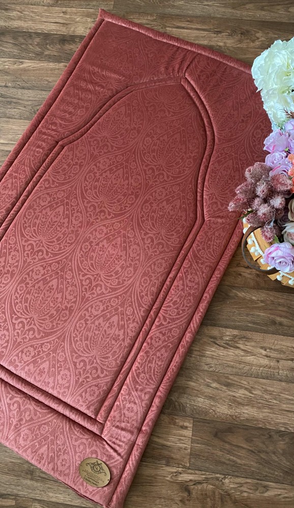 An orange-reddish prayer rug
