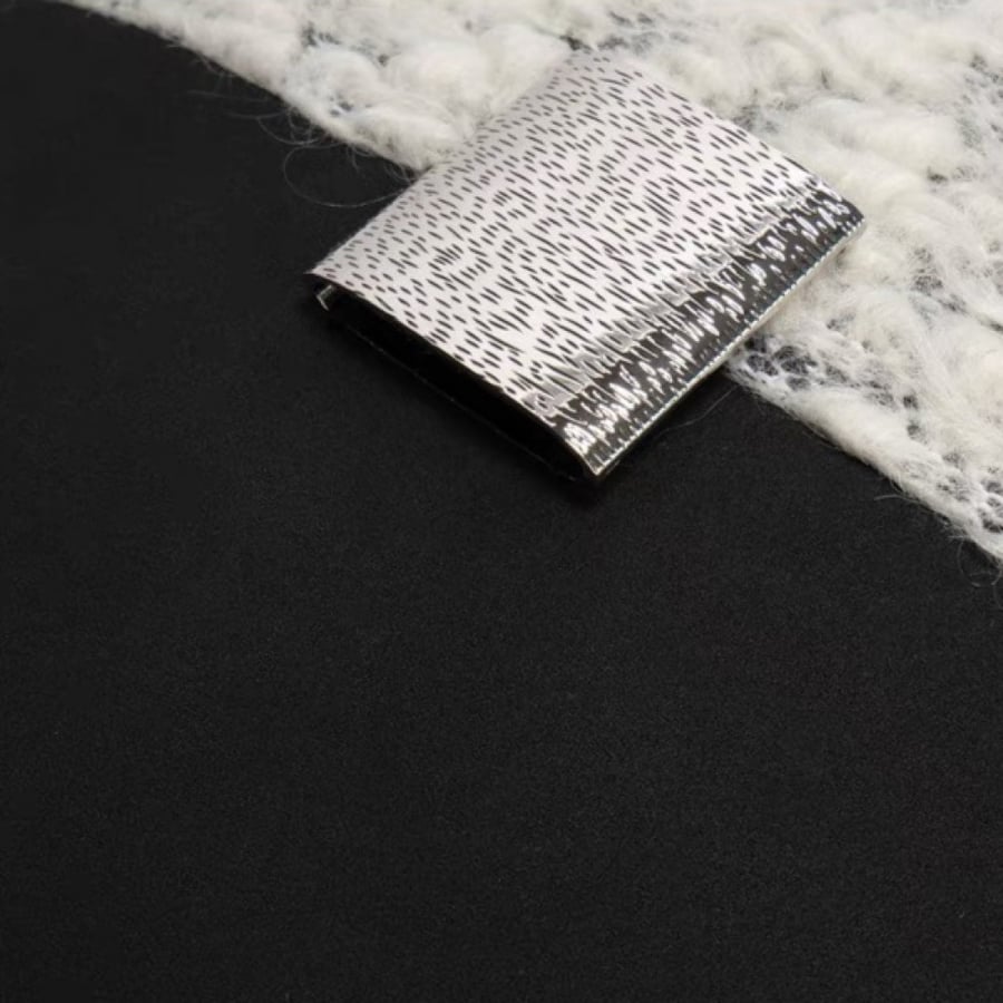 A cushion with a distinctive design made of multiple materials