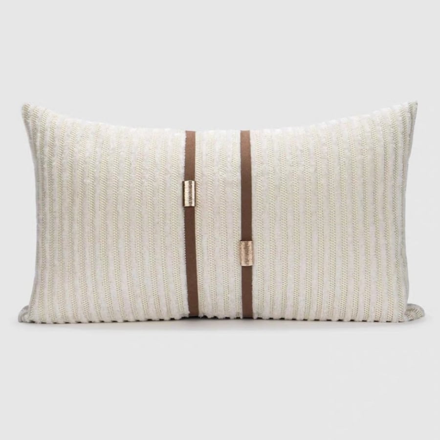 Rectangular cushion with beige woven threads and a brown strap