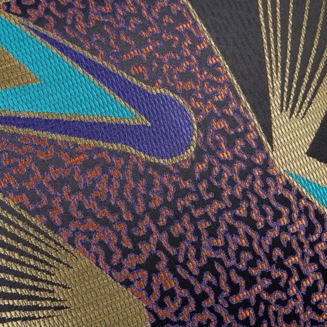 A cushion with a mix of colors black, gold, blue, purple