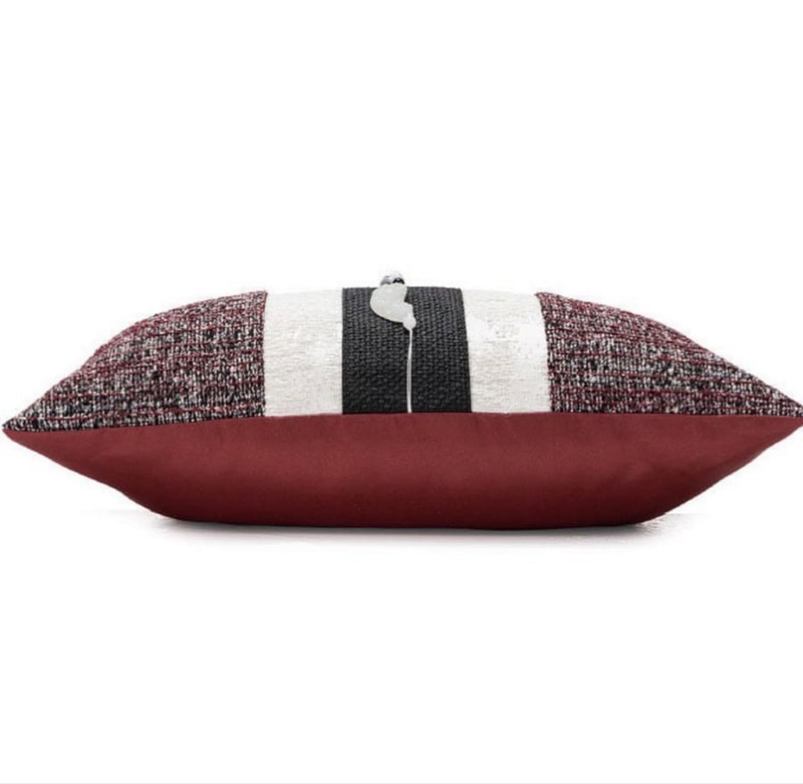 A cushion cover in maroon and black