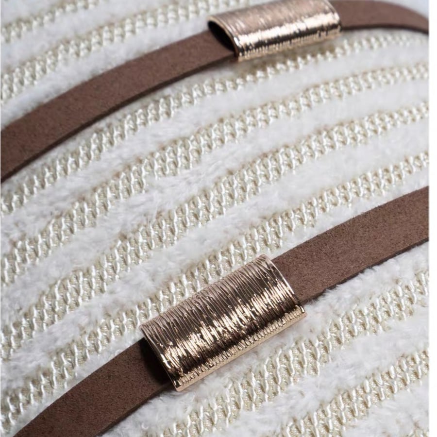 Rectangular cushion with beige woven threads and a brown strap