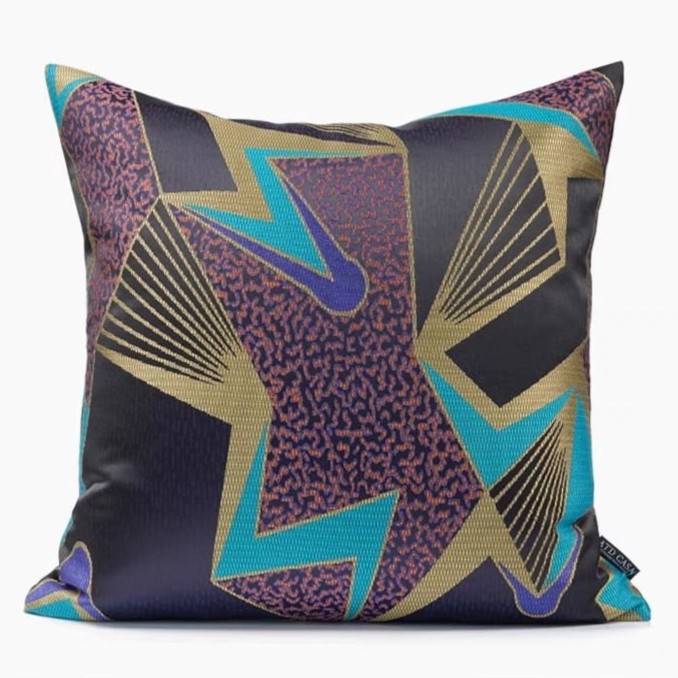 A cushion with a mix of colors black, gold, blue, purple