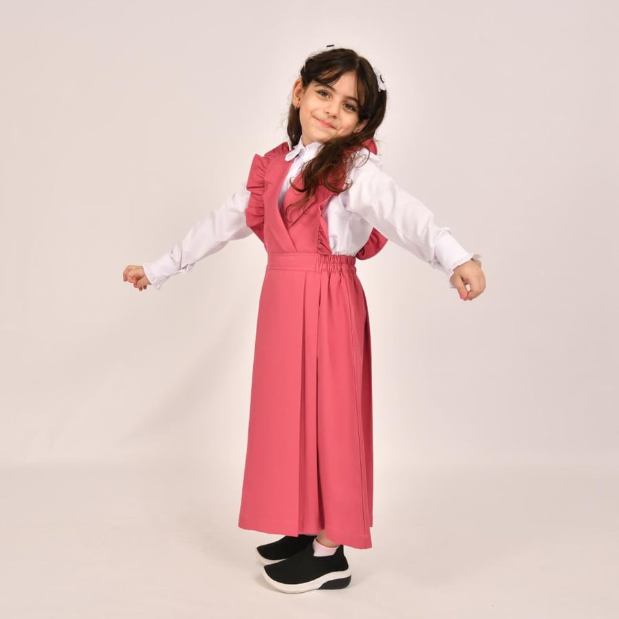 Light pink primary apron with wide ruffle on the shoulders and pleats at the bottom