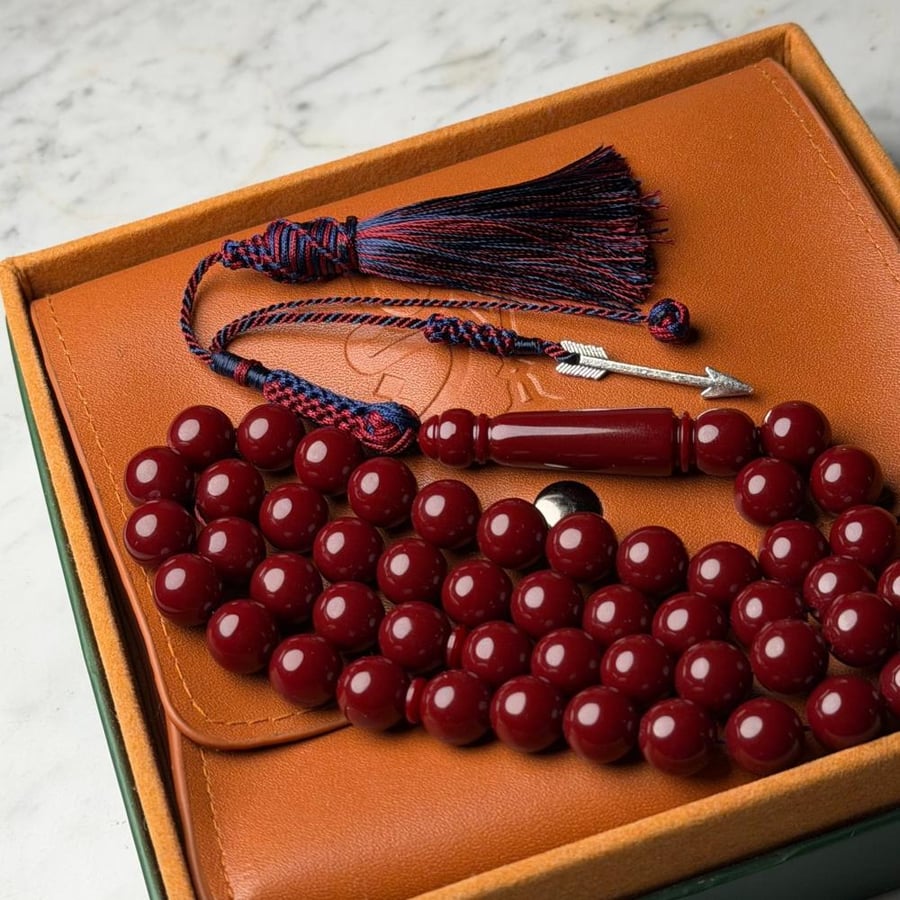An agate prayer bead bracelet in reddish-orange.