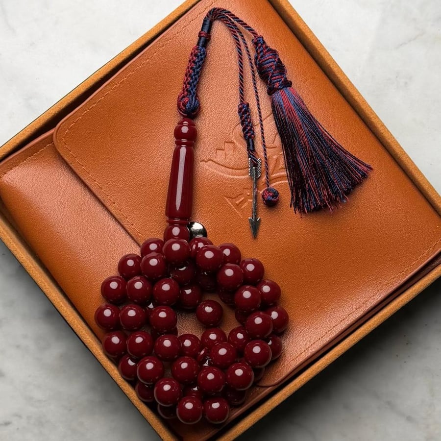 An agate prayer bead bracelet in reddish-orange.