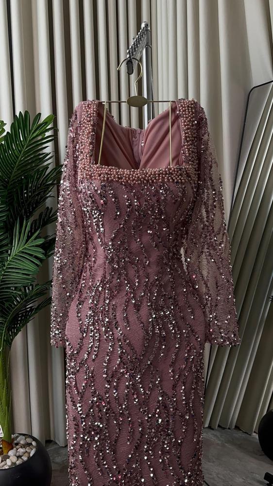 Elegant evening dress decorated with pearls and sequins, made of crinkled fabric