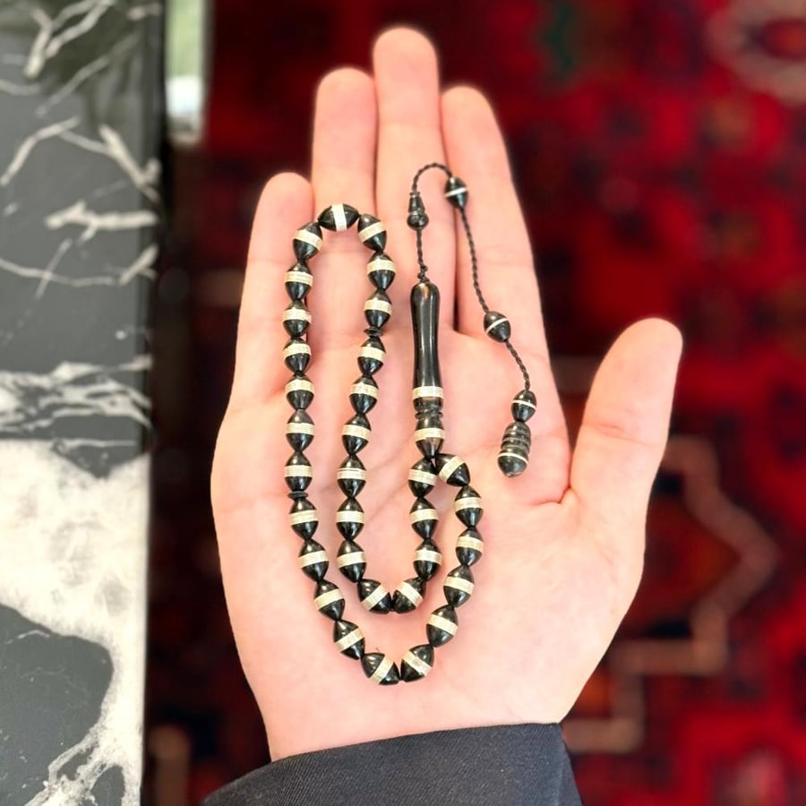 Wooden prayer beads embedded with silver