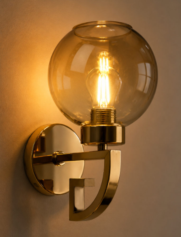 A gold wall clock with amber glass in a luxurious modern design