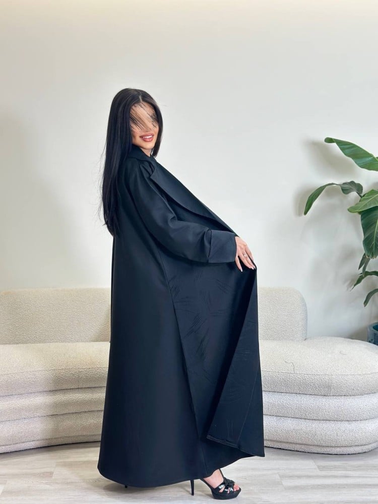A Jakar fabric abaya with a loose fit, and in the back a black Julia fabric, with a black headscarf.