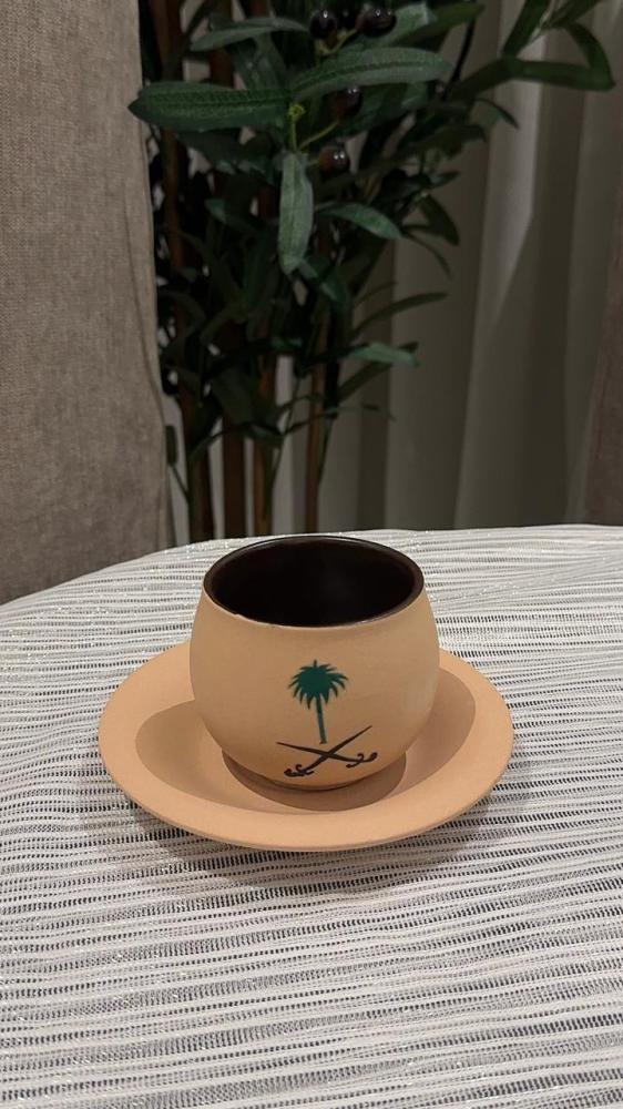 كوب فخار مع صحن بشعار السعودية