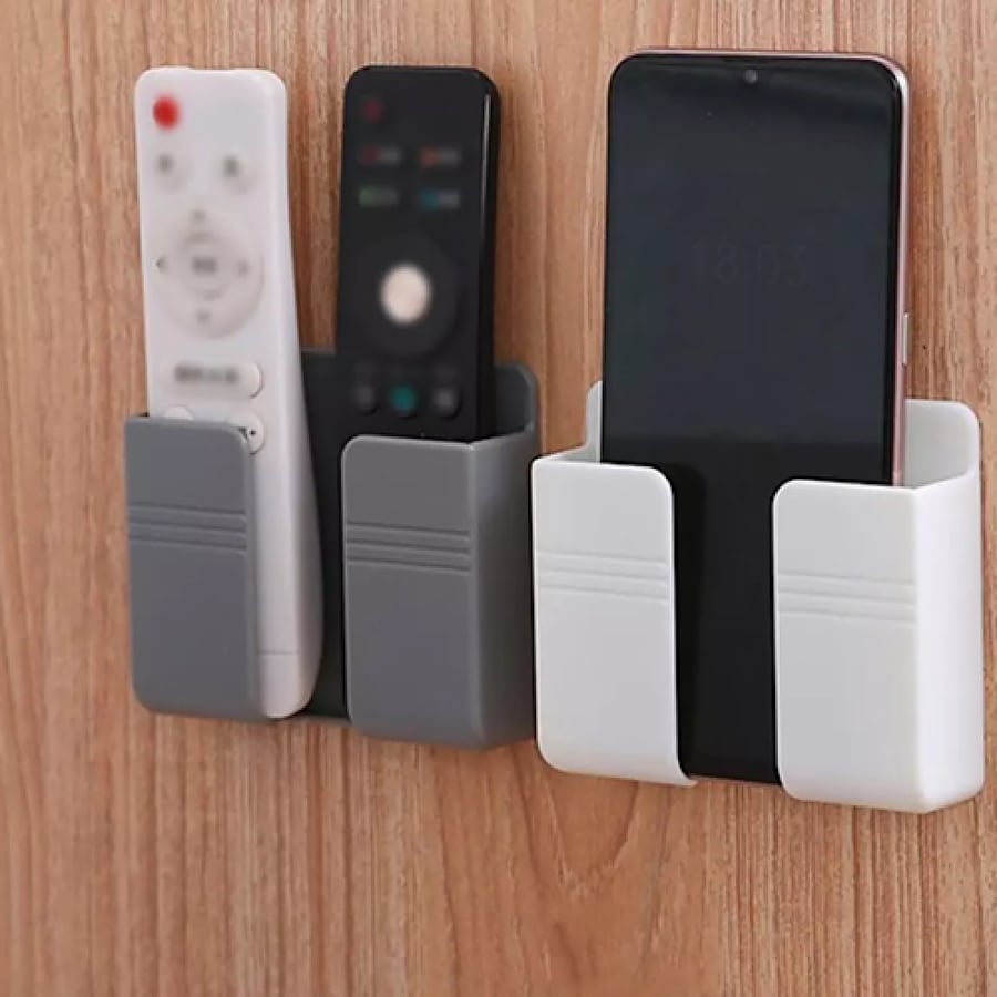 Wall-mounted phone holder with adhesive