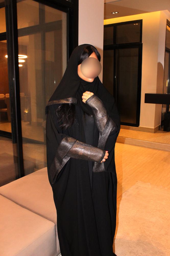 Black half bisht abaya finished with double-layered sleeves and a soft gold shimmer