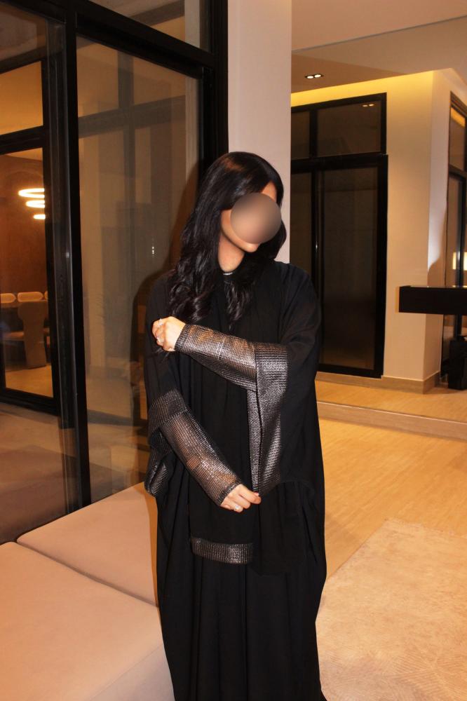 Black half bisht abaya finished with double-layered sleeves and a soft gold shimmer