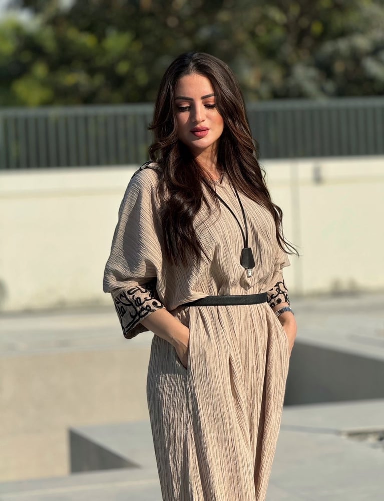 Beige overall with Arabic writing and hoodie