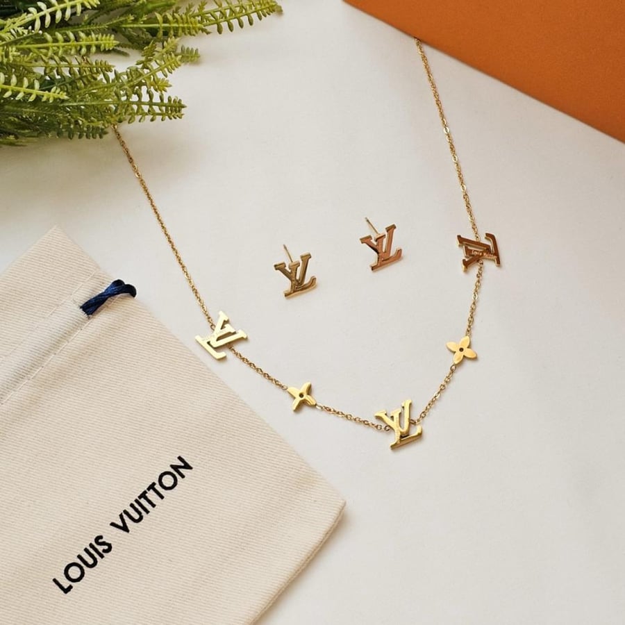 A necklace set with a Louis Vuitton ring