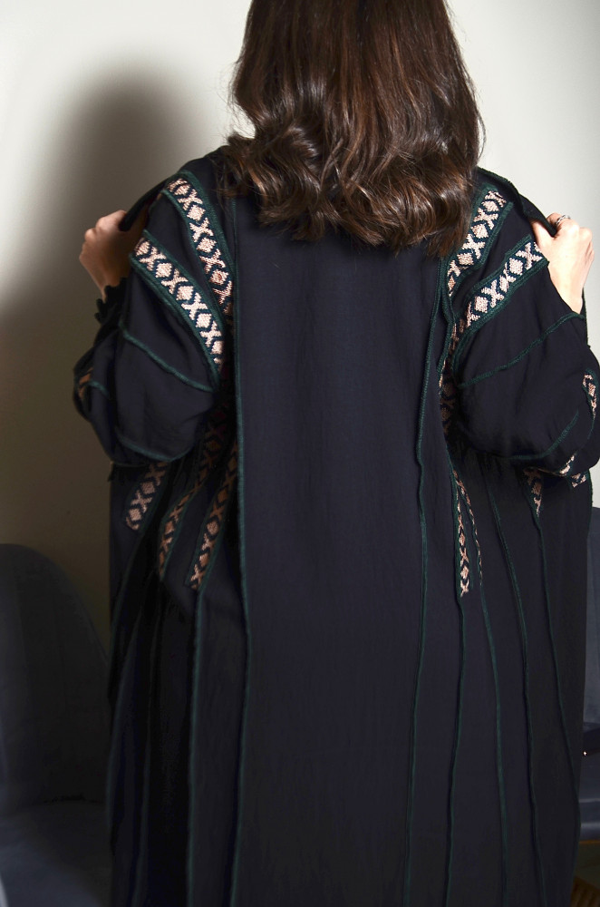 Royal crepe fabric abaya with a model in the front and back, and embroidery with green thread