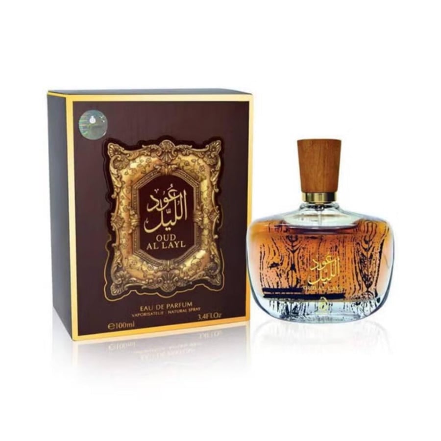 زجاجة عطر عود الليل موضوعة بجانب علبة التغليف الخارجية