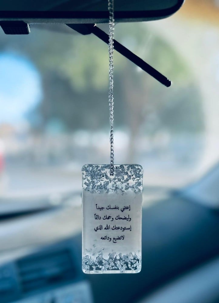 A double-sided car pendant with an elegant design made of luxurious resin