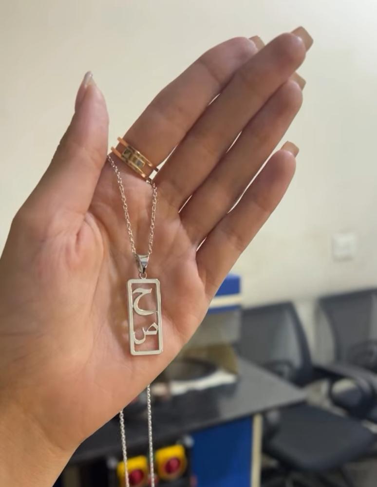 The pendant of the two letters in a vertical luxurious way