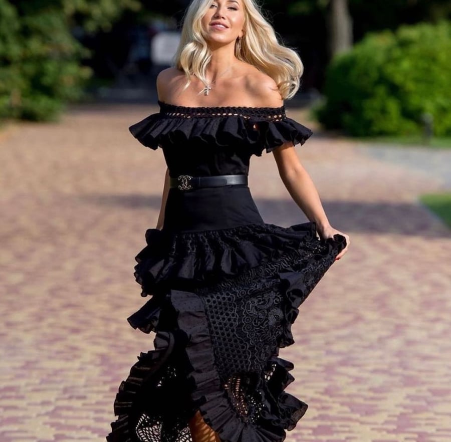 European black dress decorated with ruffles and frills note the belt is plain