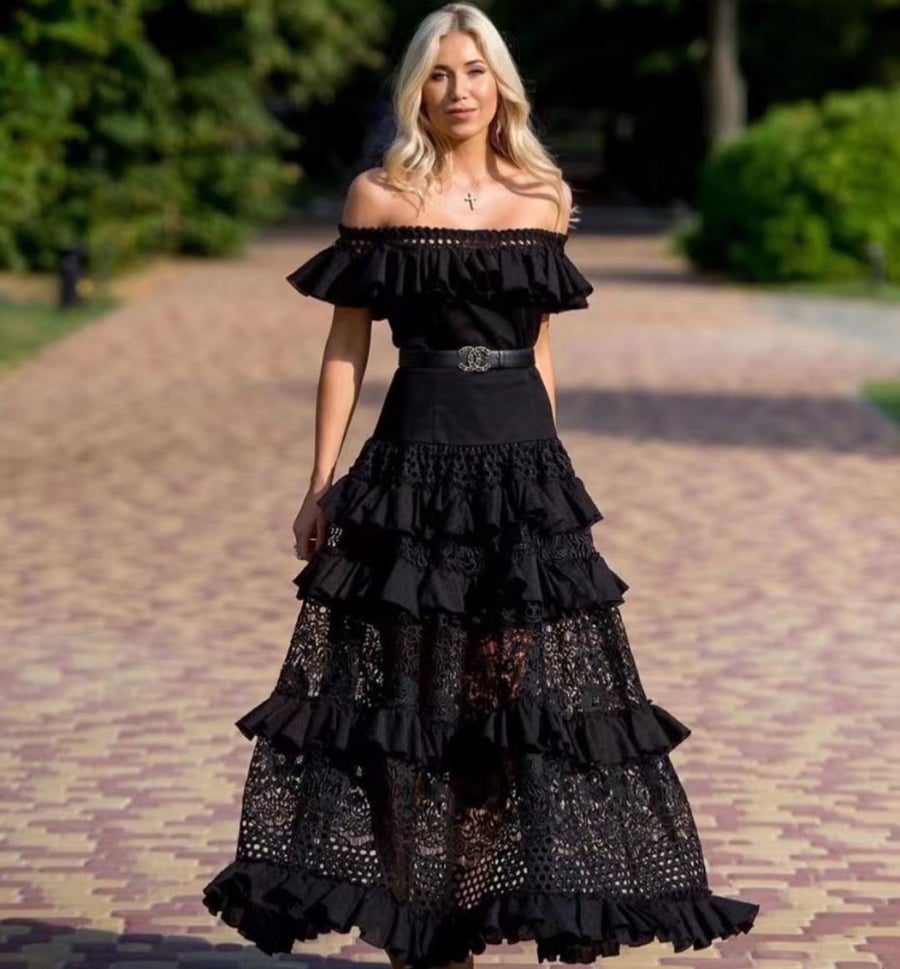 European black dress decorated with ruffles and frills note the belt is plain