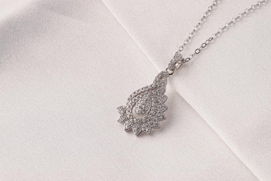 Half of a 925 silver set plated with rhodium with a diamond design
