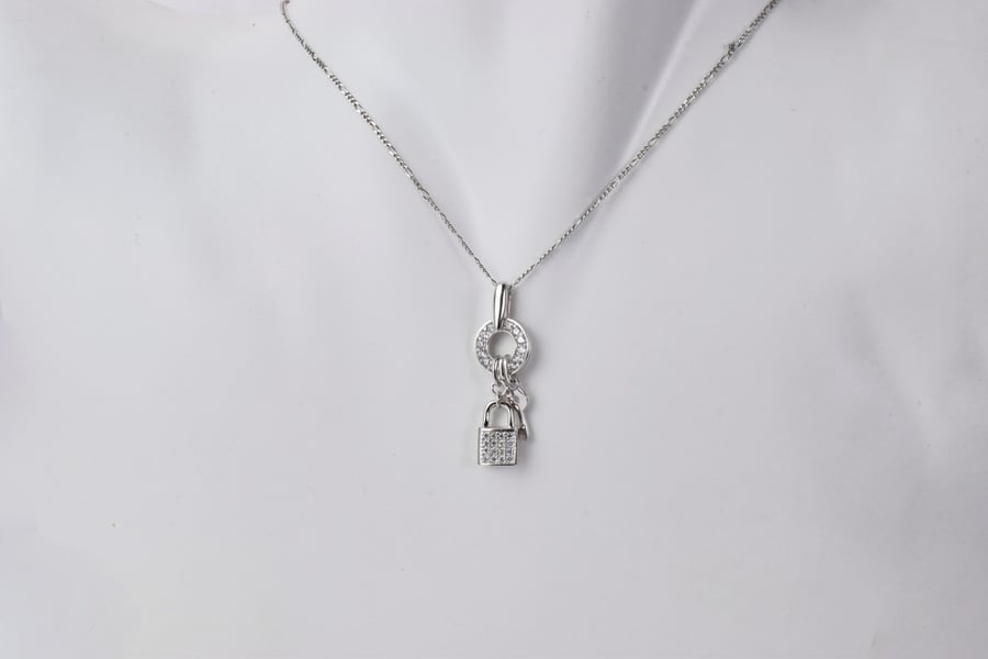A pendant in the shape of a silver-colored lock