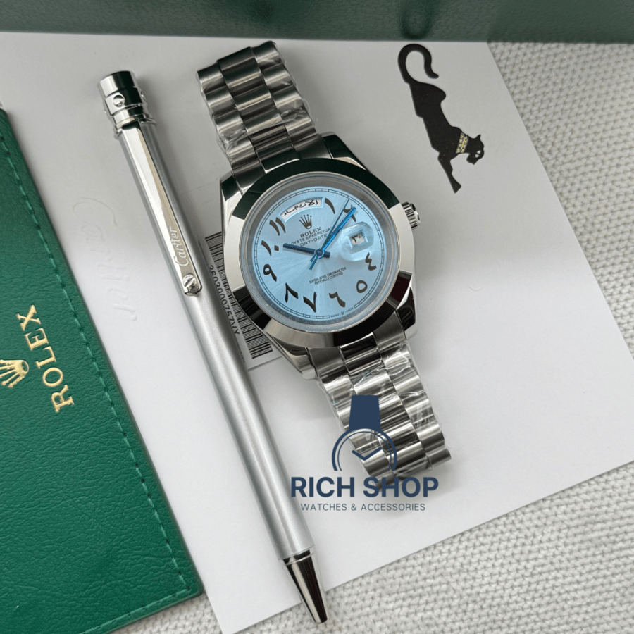 Sky blue Rolex watch set with a thin silver Cartier pen