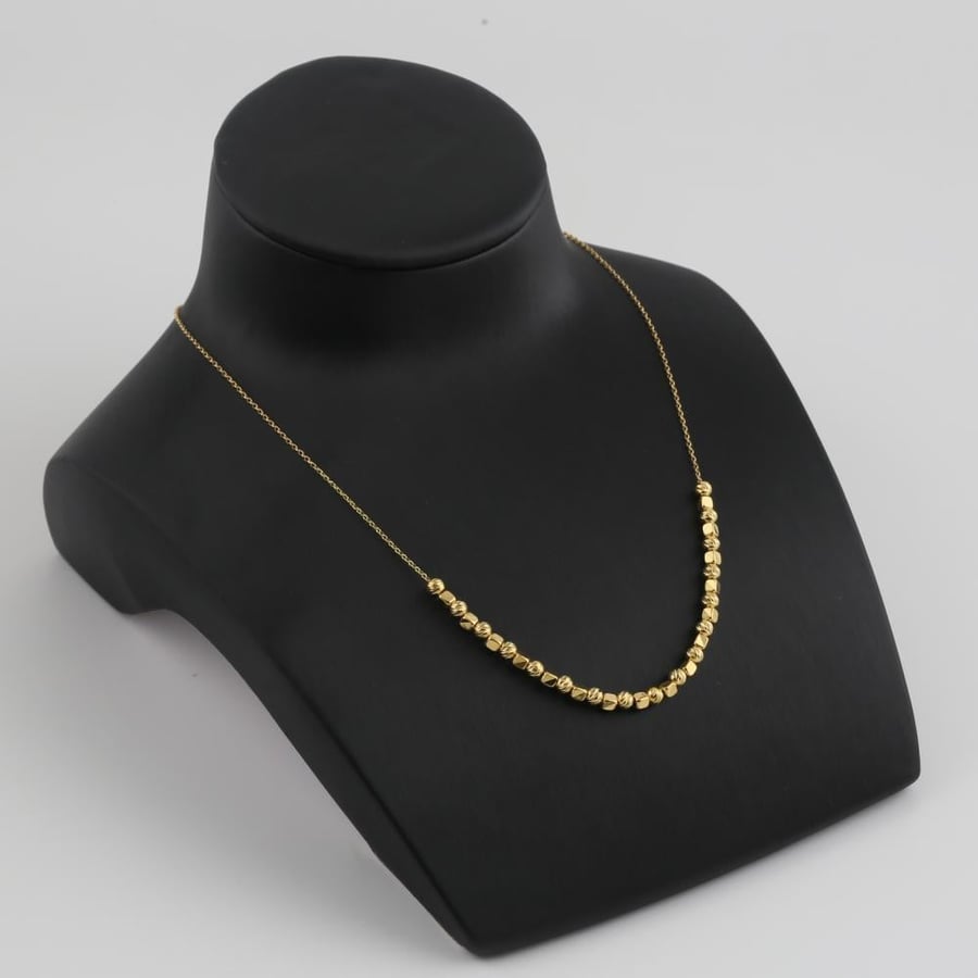 Half a gold set with geometric gold shapes - 21 karat