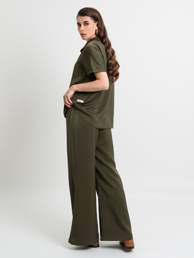 طقم بنطلون بقصة واسعة من الأسفل مع قميص بولو بقماش بملمس حريري ناعم - زيتي