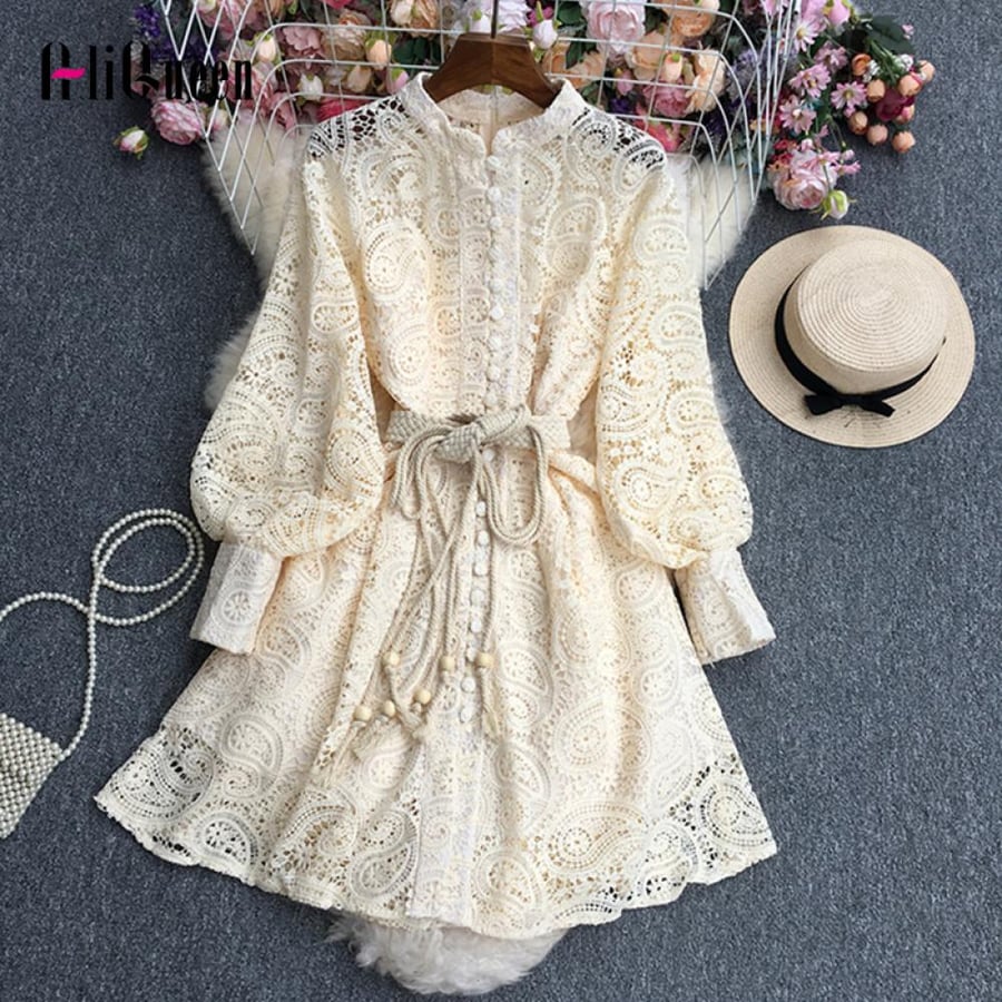 A short dress made of lace with an elegant belt