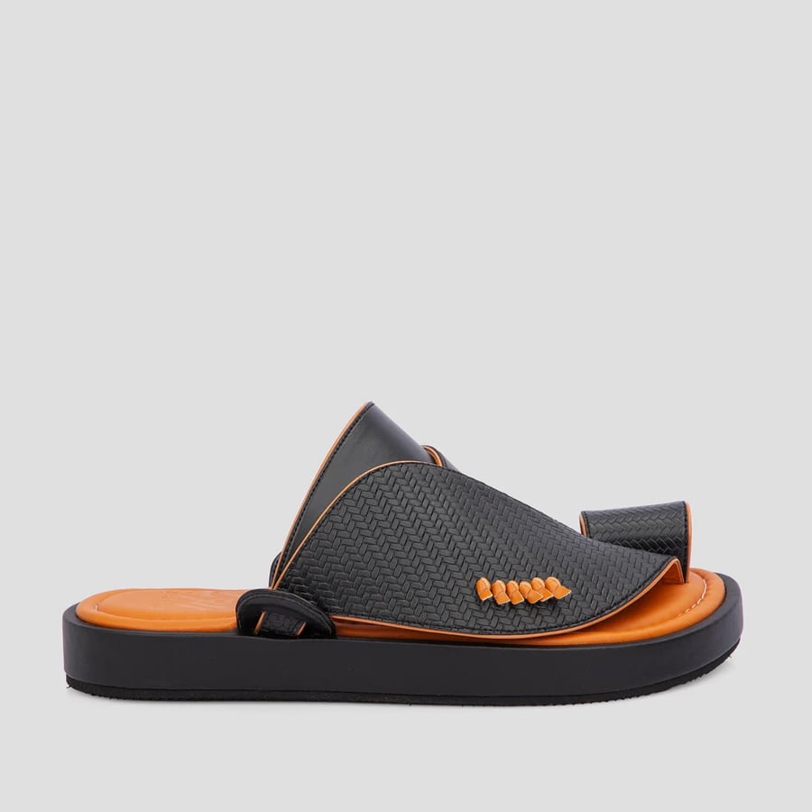 A Saudi oriental shoe made of the best black and orange leather materials
