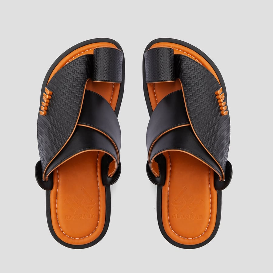 A Saudi oriental shoe made of the best black and orange leather materials