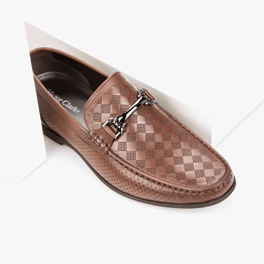 Formal brown shoe with a distinctive pattern from Victor Clark