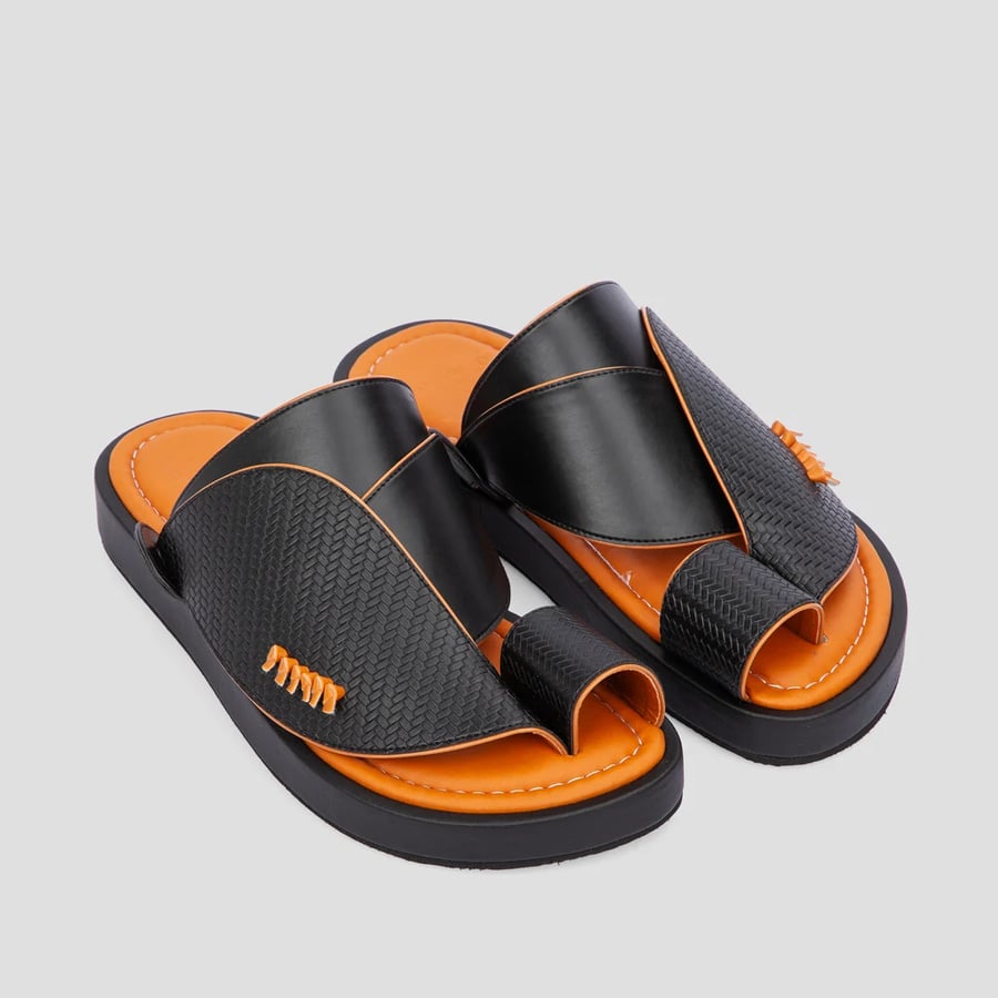 A Saudi oriental shoe made of the best black and orange leather materials
