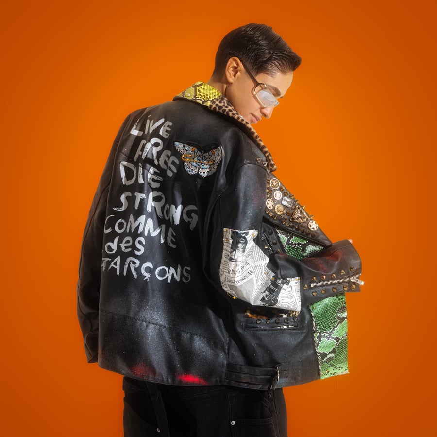Black leather jacket with a diverse mix of genuine leather and handmade accessories